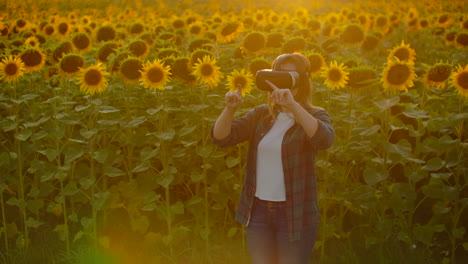 Female-modern-farmer-in-a-field-with-sunflowers-uses-VR-technology.-Simulating-the-application's-user-interface.-Control-the-irrigation-system-with-drones.-Inspect-the-field-using-drones.